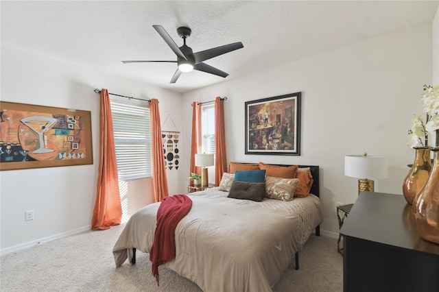 carpeted bedroom with baseboards, a textured ceiling, and ceiling fan