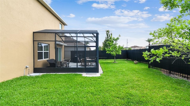 view of yard with a lanai, a fenced backyard, and a patio area