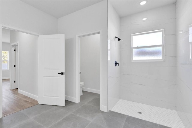 full bath with toilet, recessed lighting, baseboards, and a marble finish shower