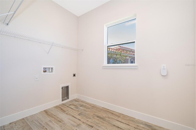 2400 Symphony Cir, Saint Cloud, FL 34771 - washroom with hookup for an electric dryer, baseboards, light wood-style flooring, laundry area, and hookup for a washing machine