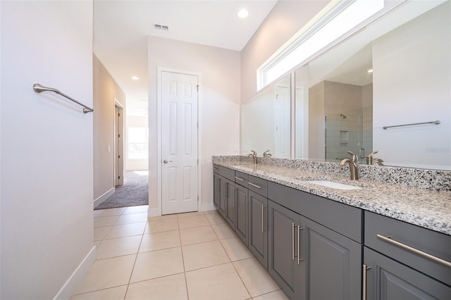 2400 Symphony Cir, Saint Cloud, FL 34771 - full bathroom with baseboards, double vanity, a shower stall, visible vents, and a sink