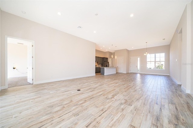 2400 Symphony Cir, Saint Cloud, FL 34771 - unfurnished living room with light wood-style floors, baseboards, and recessed lighting
