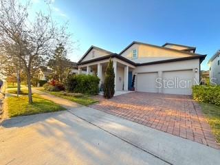 view of front of property with decorative driveway and a garage