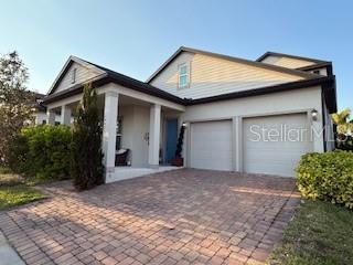 view of front of property featuring a garage, decorative driveway, and stucco siding