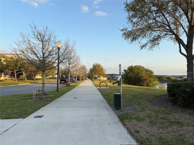 view of property's community featuring a yard and a water view