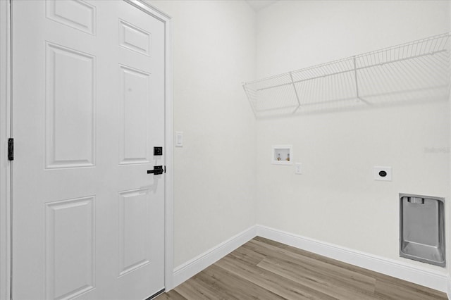 laundry room with hookup for a washing machine, baseboards, laundry area, light wood-style flooring, and electric dryer hookup