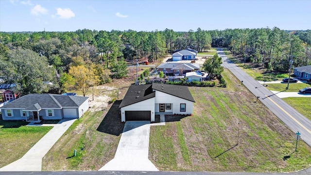 drone / aerial view featuring a wooded view