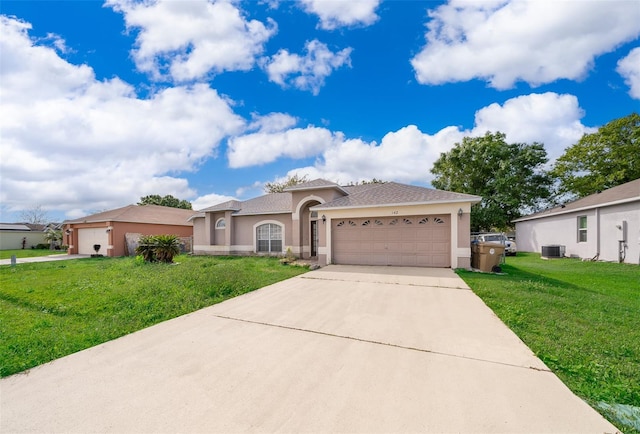 view of front of home featuring central AC unit, driveway, stucco siding, a front lawn, and a garage