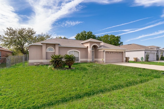 view of front of home with stucco siding, an attached garage, concrete driveway, and a front lawn