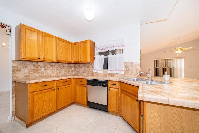 kitchen featuring dishwasher, light countertops, decorative backsplash, a peninsula, and a sink