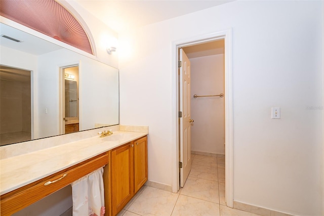 bathroom with visible vents, vanity, and baseboards