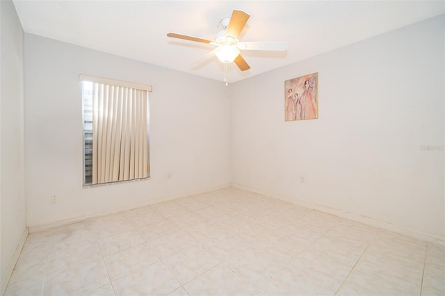 unfurnished room featuring baseboards and ceiling fan