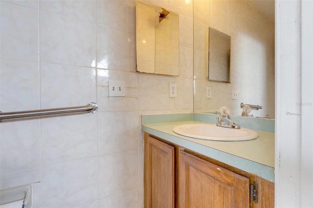 bathroom featuring vanity and tile walls