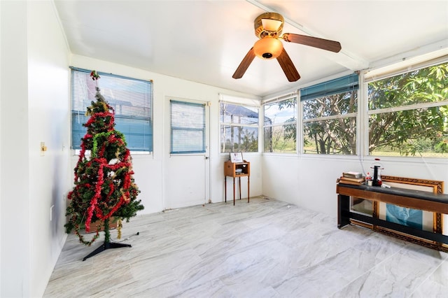 sunroom featuring a ceiling fan