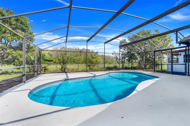 pool featuring a patio area and glass enclosure