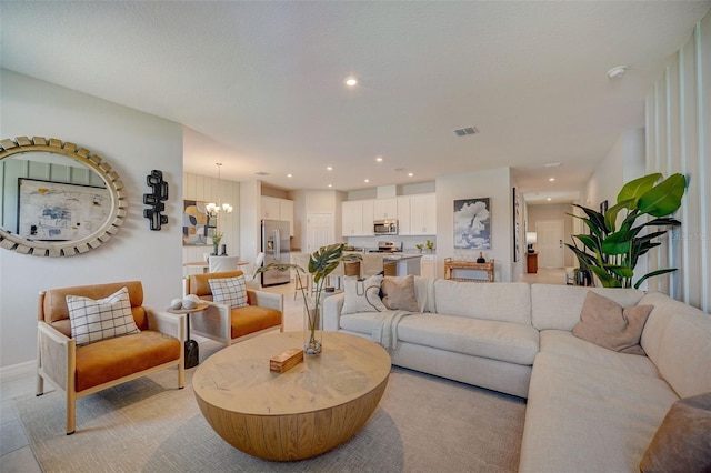 living room featuring a notable chandelier, recessed lighting, and visible vents