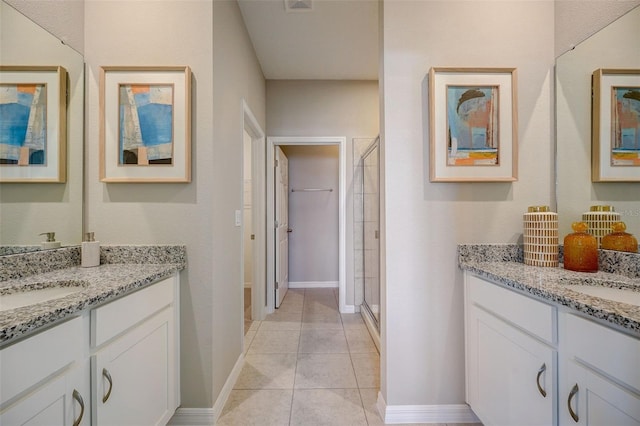 full bath with a sink, two vanities, and a shower stall