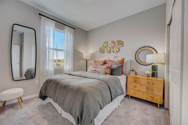 carpeted bedroom featuring baseboards