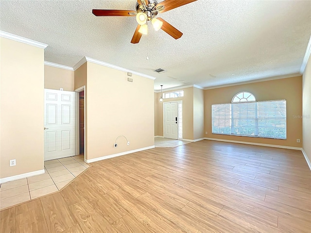 interior space featuring a ceiling fan, visible vents, light wood finished floors, a textured ceiling, and crown molding