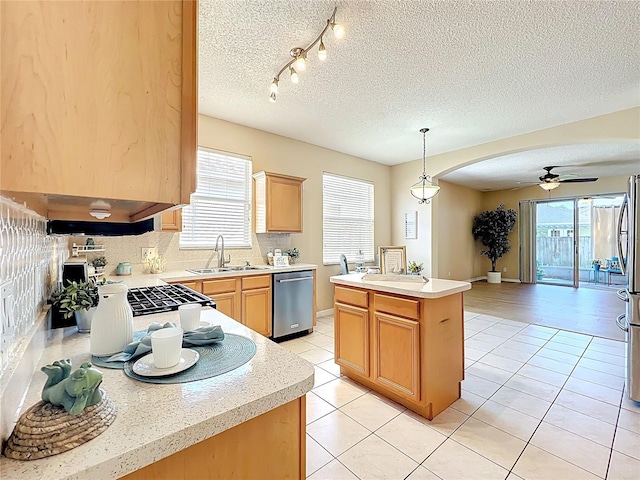 kitchen featuring a sink, light countertops, ceiling fan, and stainless steel dishwasher