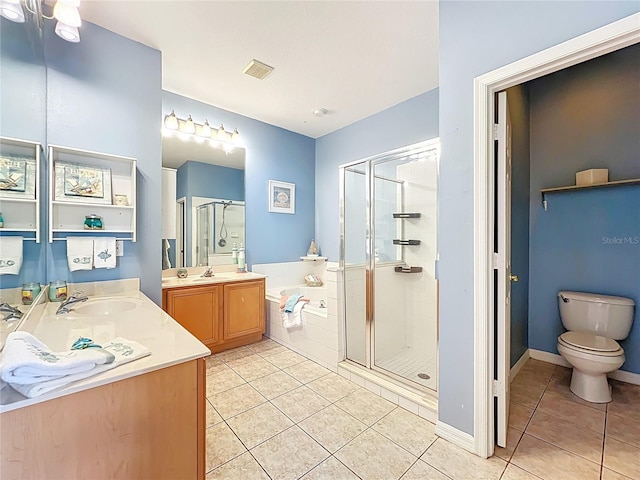 bathroom with a sink, visible vents, a stall shower, and tile patterned flooring