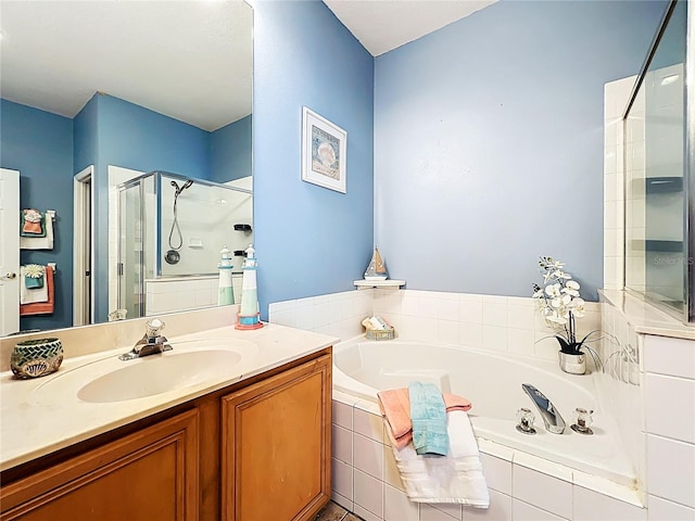 bathroom featuring a garden tub, a stall shower, and vanity