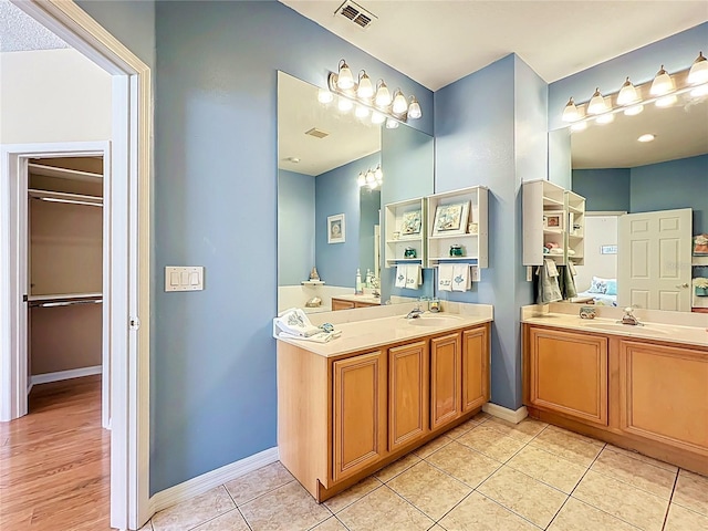 full bath with visible vents, baseboards, vanity, and tile patterned flooring