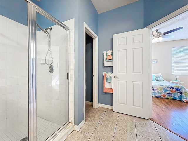 ensuite bathroom featuring tile patterned floors, a stall shower, and ensuite bathroom