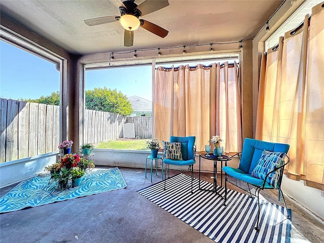 sunroom / solarium featuring ceiling fan