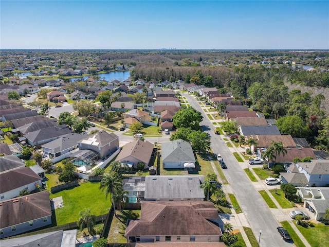 drone / aerial view featuring a residential view and a water view