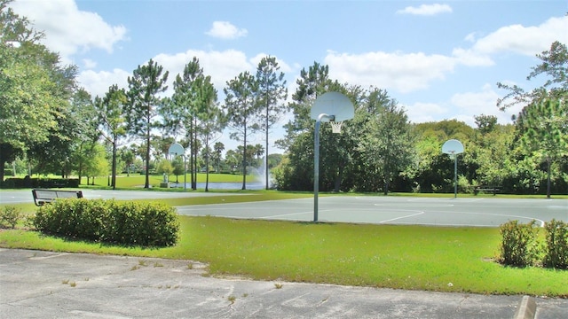 view of basketball court featuring community basketball court and a lawn