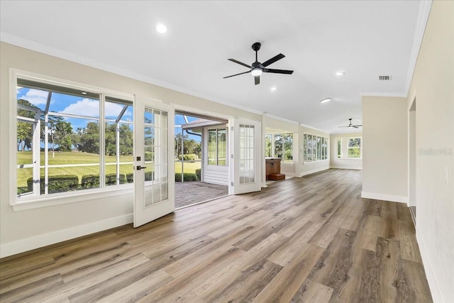 unfurnished sunroom featuring visible vents, lofted ceiling, ceiling fan, and french doors