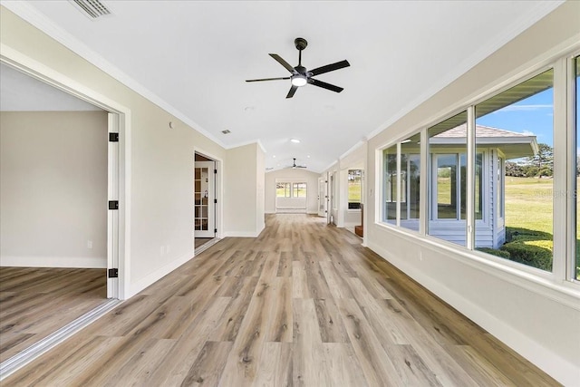 unfurnished sunroom with lofted ceiling, a ceiling fan, and visible vents