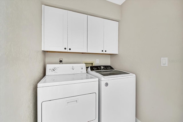 laundry room with cabinet space and separate washer and dryer