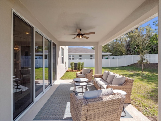 view of patio / terrace featuring a ceiling fan, an outdoor living space, and a fenced backyard