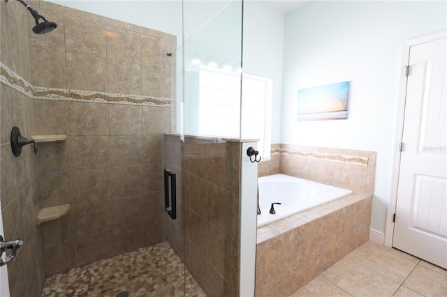 full bath with tile patterned floors, a stall shower, and a garden tub