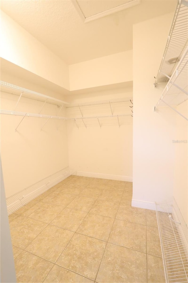 walk in closet featuring light tile patterned flooring