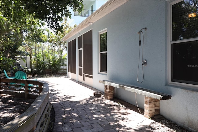 view of patio / terrace with a sunroom