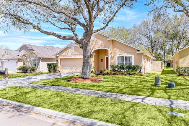 view of front of home with a front lawn, fence, aphalt driveway, stucco siding, and a garage