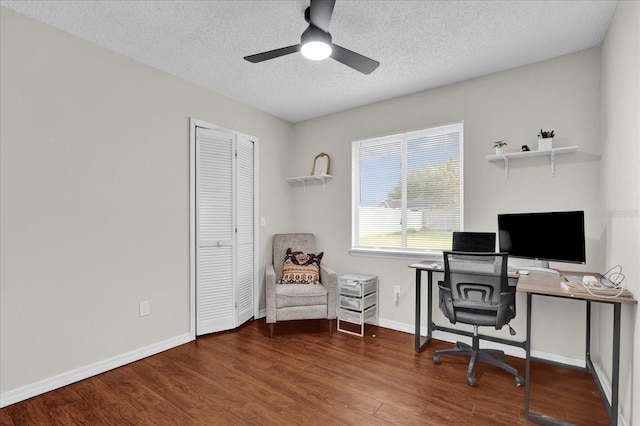 home office featuring baseboards, a textured ceiling, a ceiling fan, and wood finished floors