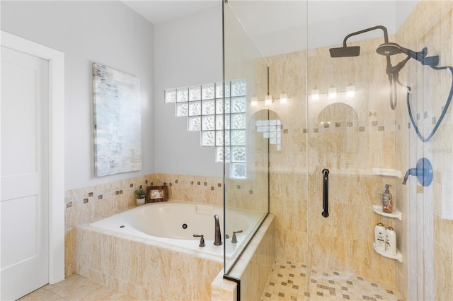 bathroom with tile patterned floors, tiled shower, and a jetted tub