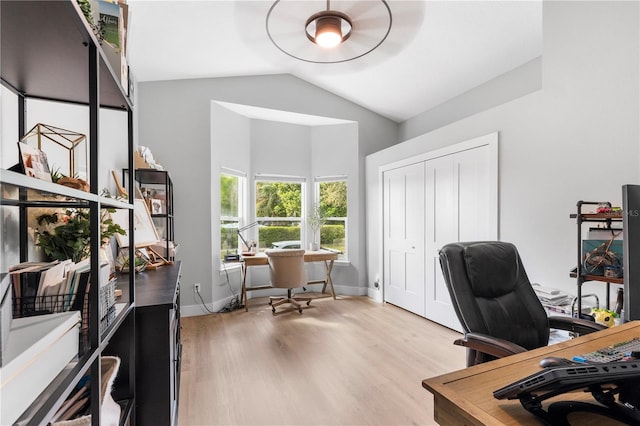 office with baseboards, wood finished floors, and vaulted ceiling