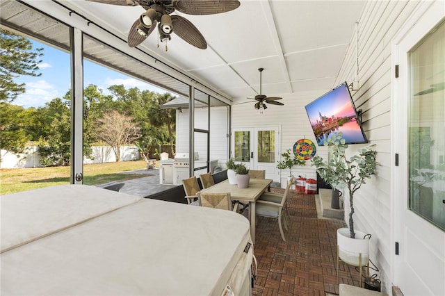 sunroom / solarium with a wealth of natural light and ceiling fan