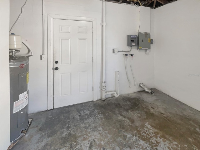 unfinished below grade area with electric panel and electric water heater