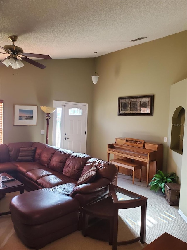 living area with visible vents, light colored carpet, ceiling fan, and a textured ceiling