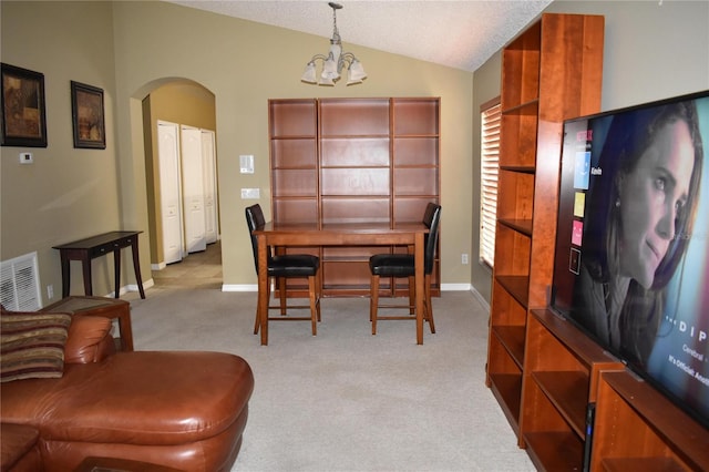 dining room with visible vents, light colored carpet, lofted ceiling, arched walkways, and a notable chandelier