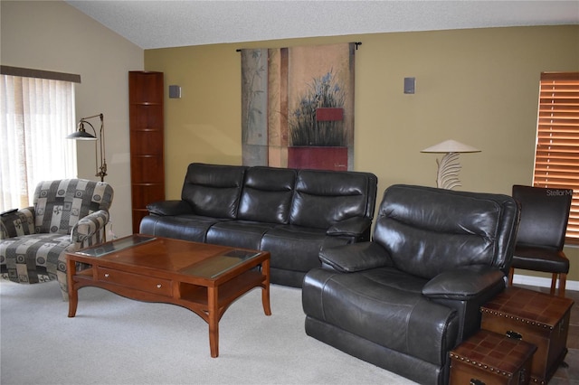 carpeted living area with lofted ceiling