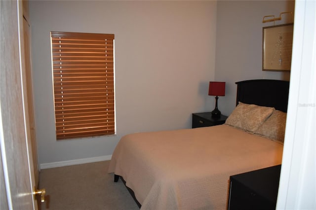 bedroom featuring baseboards and carpet