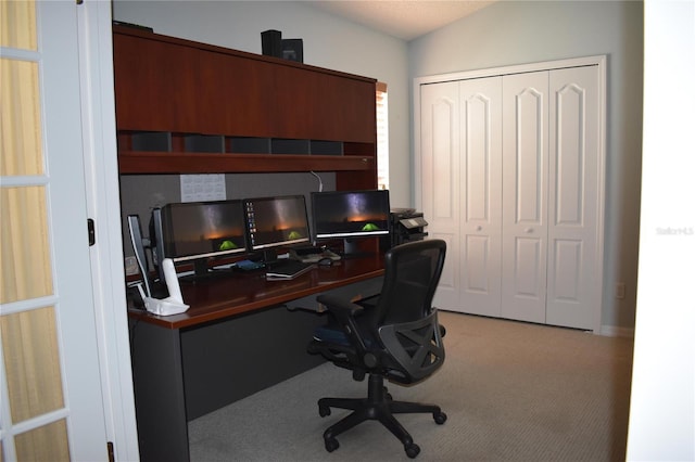 carpeted office featuring vaulted ceiling