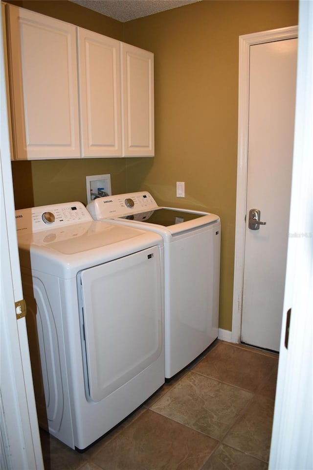 washroom with washer and dryer and cabinet space